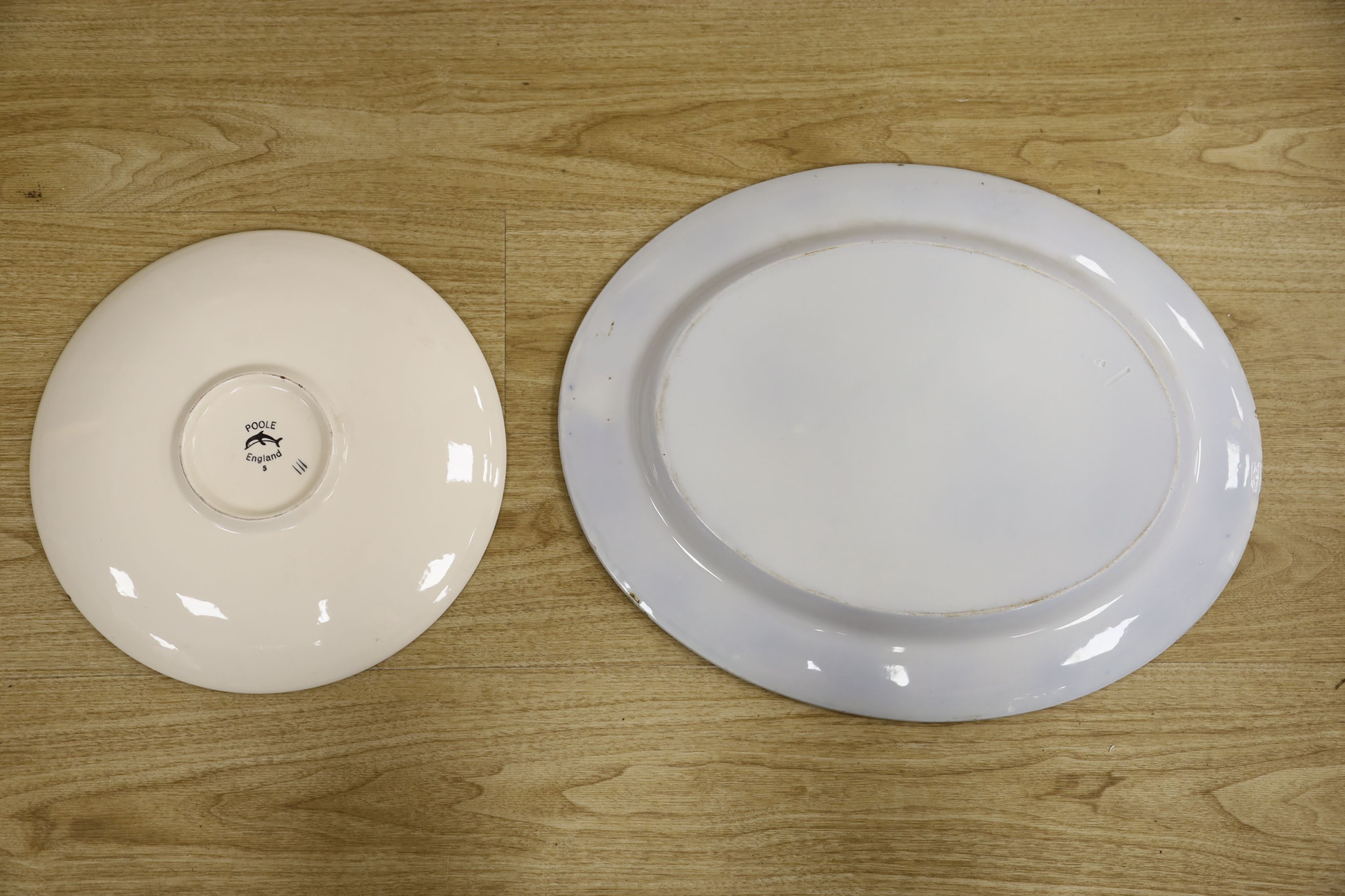 A Poole pottery charger and a blue and white oval Ashworth dish, length 55cm